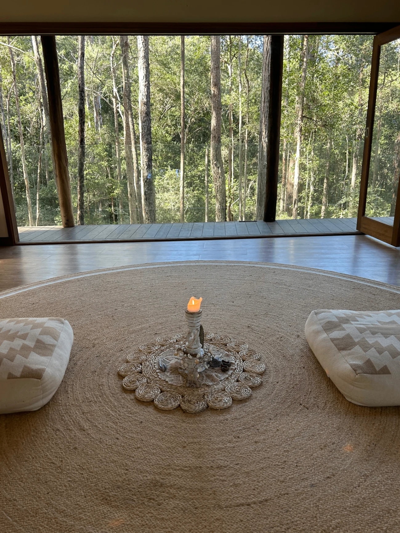 The temple room at Ilkley Haven with cushions, altar candle and open forest views